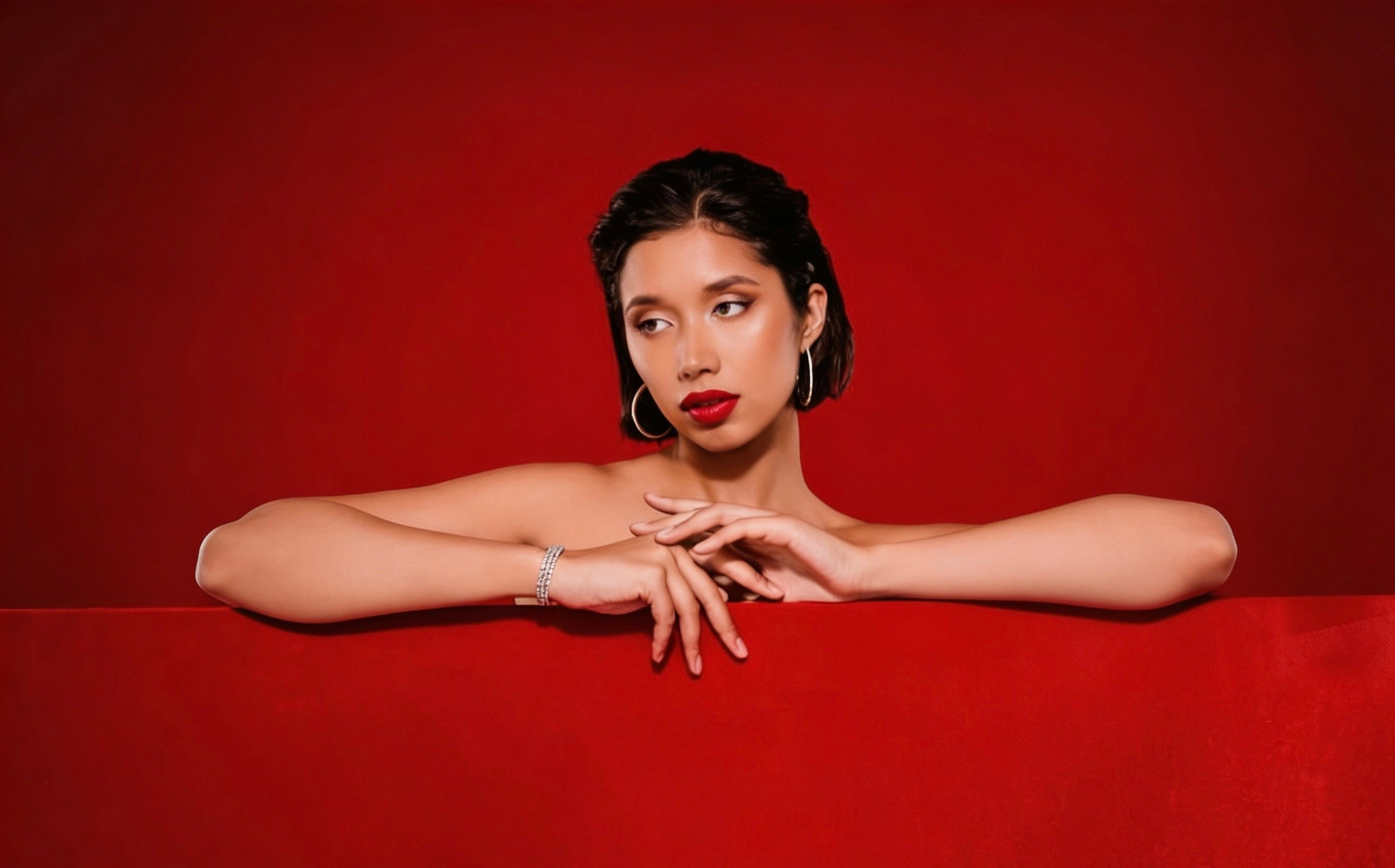 RAINA DIAMOND fine jewelry portrait against a red background